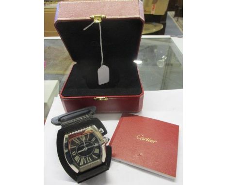 A modern Cartier Roadster desk/travel alarm clock in a black leather case converting to a stand, with original box and manual