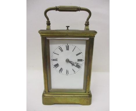 A late 19th/early 20th century brass repeating Grande Sonnerie carriage clock having bevelled glass, white enamel dial and Ro
