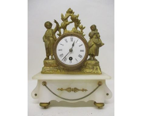 A 19th century French mantle clock decorated with two gilt metal figures, raised on a white marble base, 12" h x 9 1/2"w 