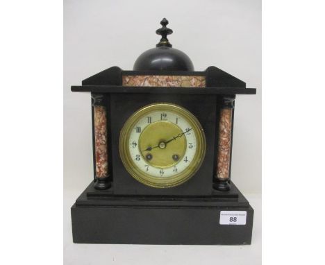 A late 19th century marble mantle clock having mottled, marble columns, the dial having a white chapter ring and a mottled ce
