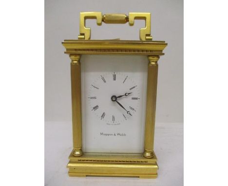 A 1980s Mappin &amp; Webb brass cased carriage clock having a white enamel dial, Roman numerals, bevelled glass windows and p