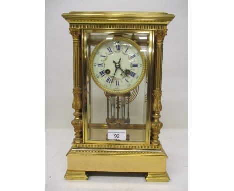 A late 19th century French gilt metal and four glass mantle clock. The case having Corinthian columns, stepped feet and bevel