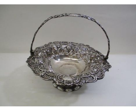 A Victorian silver basket by Henry Wilkinson &amp; Co, Sheffield 1943, with a cast handle and embossed bowl decorated with fl