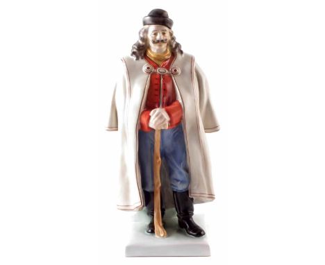 Herend figure of a gentleman, modelled by J. Istok, dressed in winter overcoat and hat holding a walking stick, printed marks