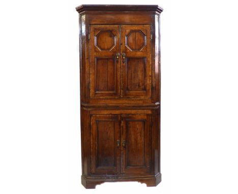 Late 18th century oak floor standing corner cupboard, top section with two doors, each fitted with two panels, with ogee bead