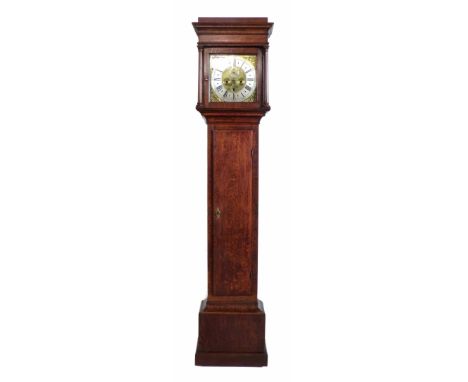 An oak longcase clock with stepped canopy supported on Doric columns framing a square brass dial with brass spandrels, silver