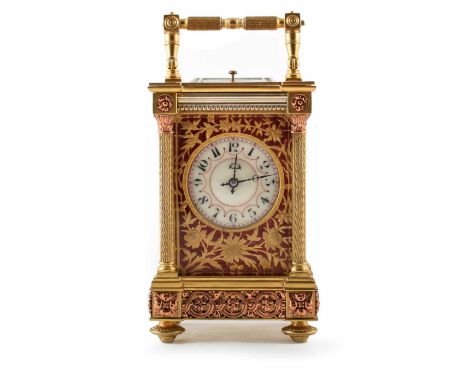 A 19th century carriage clock. Brass case with Corinthian columns and copper metal work framing an enamel face with Arabic nu
