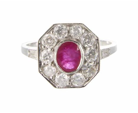 A ruby and diamond octagonal cluster 18ct white gold ring, central oval mixed cut ruby approx. 6mm x 5mm, cluster surround of