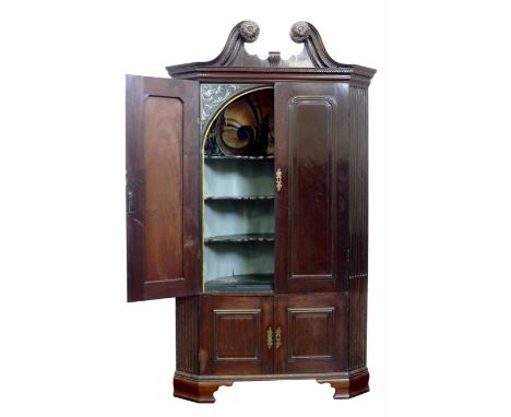 George III mahogany floor standing corner cupboard, swan neck pediment with key pattern and rosette moulding, top section wit