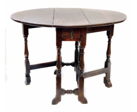 17th century oak gate-leg supper table, oval top with two leaves, original steel hinges, single drawer, baluster shaped legs 