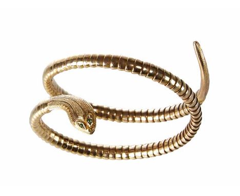 Edwardian 9ct gold snake bangle, coiled tubular design to stylized snake head front, green stone eyes, gross weight 18.9g.   