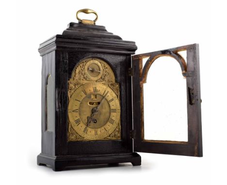 A mid 18th century ebonized bracket clock. Brass face with brass spandrels, Roman and Arabic chapter ring, subsidiary seconds