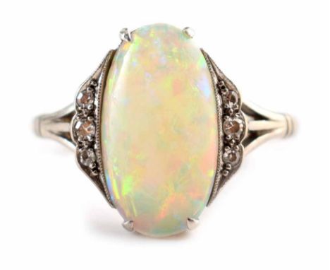 An art deco opal and diamond 18ct white gold ring, the oval cabochon cut precious opal measuring approx. 13.5mm x 7.5mm, 3 sm