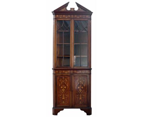 Edwardian mahogany double standing corner cupboard, architectural pediment above frieze with inlaid swags of flowers, double 