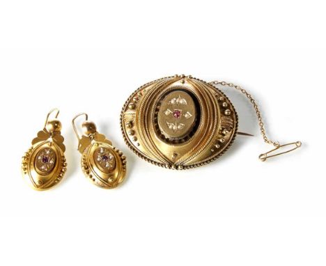 A Victorian boxed set of Etruscan style brooch and earrings, oval brooch set with ruby and seed pearls with matching drop ear