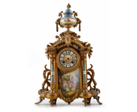 A 19th century French Ormolu mantel clock, with swags of flowers framing a porcelain dial with Roman numeral chapter ring and