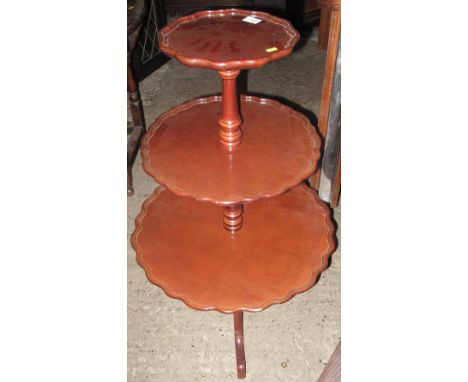 Reproduction mahogany three tier circular dumb waiter on tripod legs.