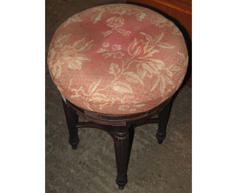 Stained and inlaid foliate upholstered circular piano swivel stool.