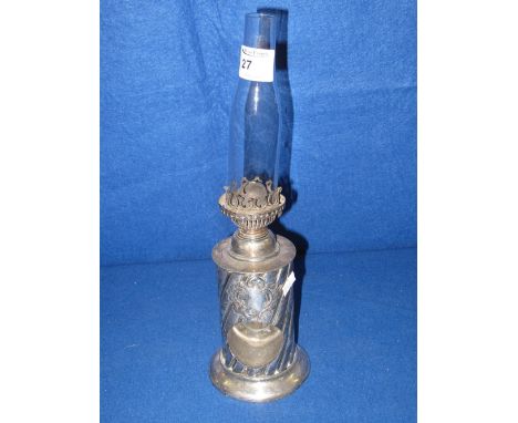 Silver plated oil lamp with wrythen cylindrical base and rear glass shade.