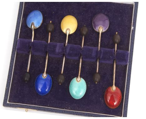 Cased set of six George V silver and enamelled coffee spoons, each with a coffee bean finial to a wire work handle, shallow b