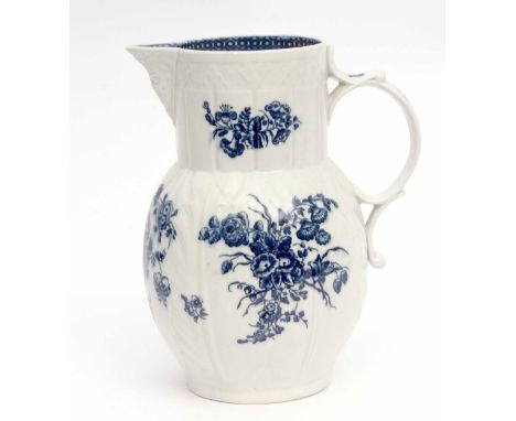 18th century Caughley cabbage leaf mask jug painted in underglaze blue with floral sprays, 23cm high 