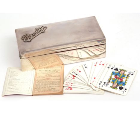 George V silver cased Bridge set of hinged rectangular form, the cover with applied and pierced detail "Bridge" to a red moro