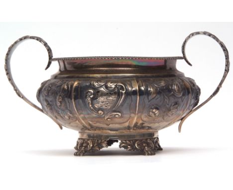 George IV two-handled sugar basin of compressed circular form with applied rim, leaf capped handles and floral and foliate em