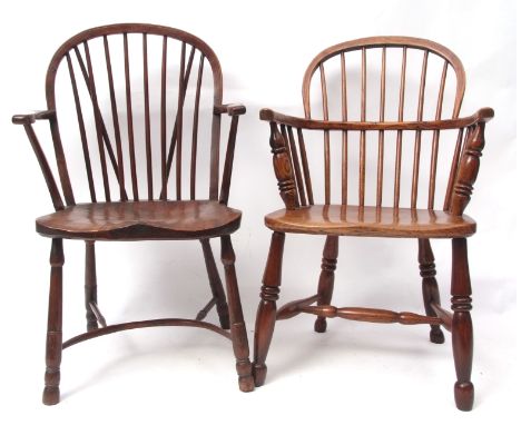 Two 19th century oak/elm stick back Windsor armchairs with solid seats, one with crinoline stretcher, the other with H stretc