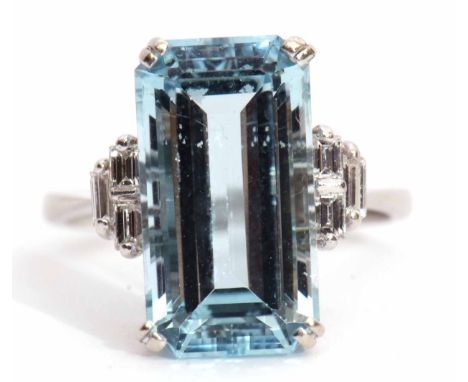 Precious metal aquamarine and diamond ring, the step-cut aquamarine set in a four-claw mount, flanked by baguette diamond set