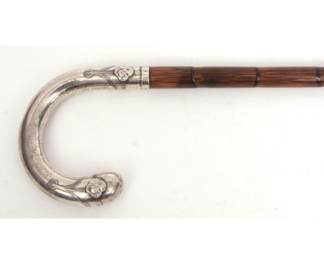 Early 20th century Continental silver handled bamboo walking stick, the crook shaped handle with stylised Art Nouveau detail 