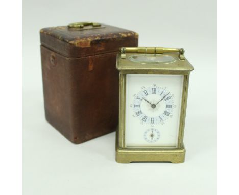 A circa 1900 French brass cased carriage clock with visible escapement and alarm (alarm mechanism incomplete) the enamel dial