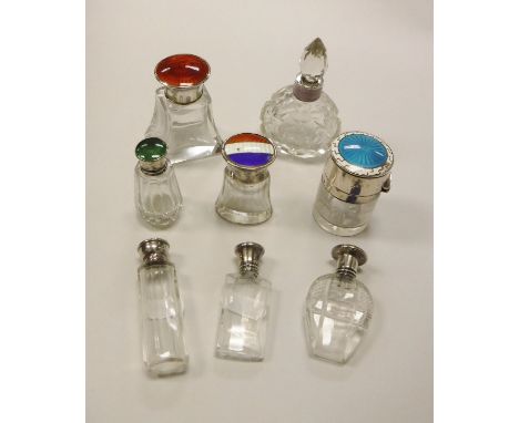 A collection of eight silver and enamel mounted scent bottles with clear glass bodies CONDITION REPORTS All scent bottles hav