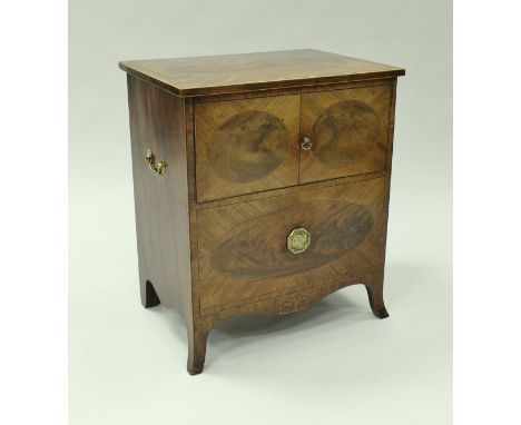 A late George III mahogany commode, the figured medallion inlaid top with cross-banding over two simulated doors rising to re