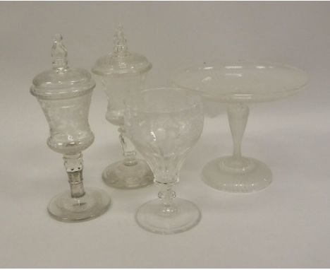 A pair of 19th Century Bohemian clear cut glass goblets of thistle form decorated with running stags and buildings (one with 