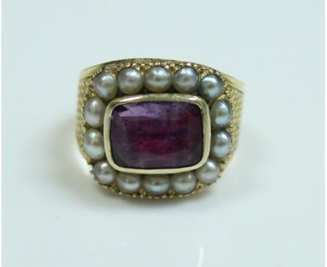 An early 19th Century gold seed pearl and amethyst set mourning ring, the rectangular amethyst surrounded by seed pearls rais
