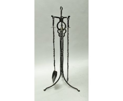 A modern wrought iron fireside companion set comprising shovel, tongs and fork on a tripod stand all with rope twist style de