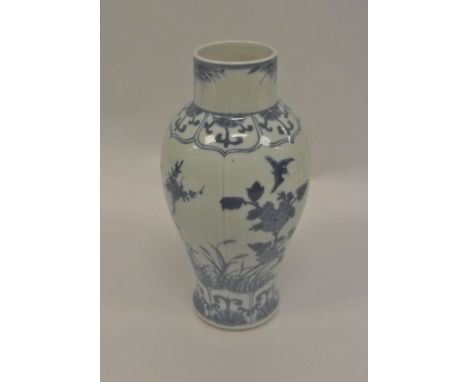 A Chinese Kangxi baluster vase of stylised squash form, the main body blue and white decorated with birds amongst blossoming 