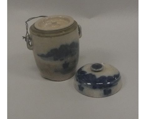 A Chinese blue and white pot and cover with inner cover decorated with a coastal landscape and figure in a canoe, 12.75 cm hi