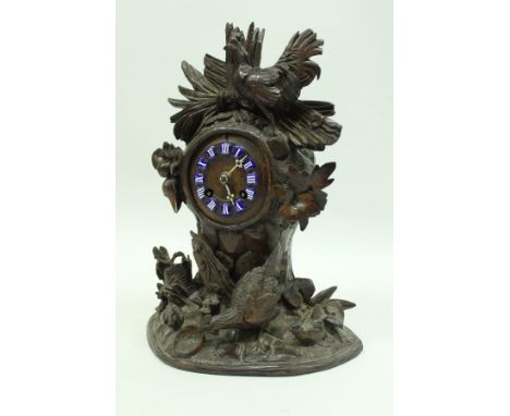 A 19th Century Black Forest type mantle clock, with cockerel and hens and leaf decoration, the dial set with blue and white e