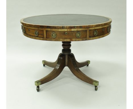 A 19th Century rosewood drum table, the tooled and gilded leather insert top over frieze drawers, raised on a turned and ring