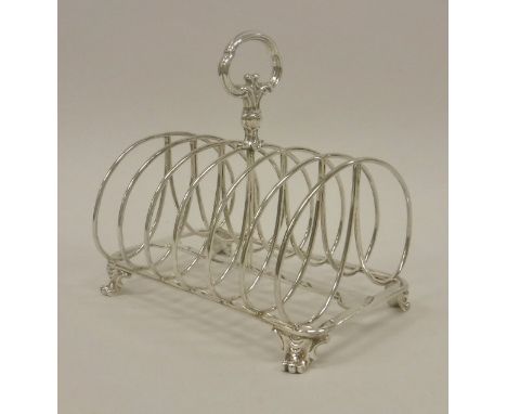 A Victorian silver six section toast rack, raised on stylised claw feet (by R &amp; S Garrard &amp; Co., London 1849), stampe