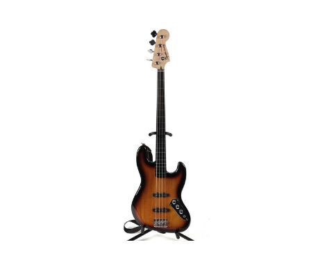 A Squier Fretless jazz bass by Fender, with maple neck, Ebonol board, three-colour sunburst finish.