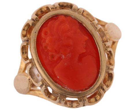 A 9ct gold coral cameo ring, relief carved depicting female profile, setting height 18mm, size M, 3.5g . Condition Report:No 