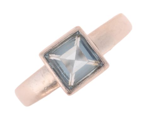 A platinum single stone aquamarine ring, maker PCJ, London 2011, rub-over set with square step-cut aquamarine weighing approx