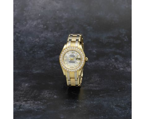 Rolex. A lady's 18K two colour gold and diamond set automatic calendar bracelet watch with diamond set mother of pearl dialMo