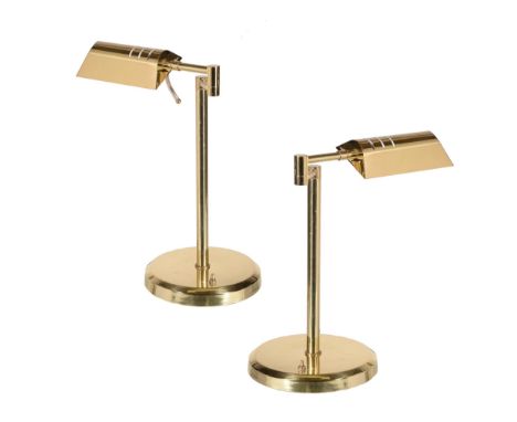  A pair of brass adjustable desk lamps,   20th century, the electrical fitments recessed into elongated domed shades, on hing