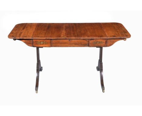  A Regency rosewood and gilt brass inset sofa table,   circa 1815, the rectangular top with twin drop leaves, inset with bras