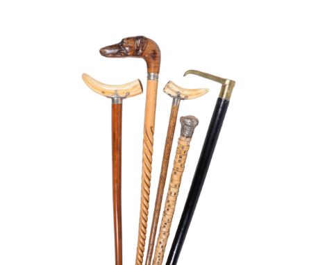  Four various walking sticks and canes,   late 19th century, comprising a marine vertebrae example with hallmarked silver kno