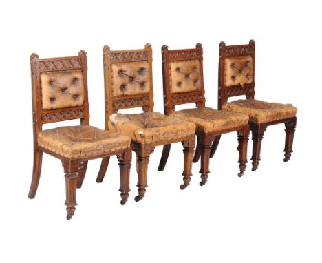  A set of four carved Victorian Gothic Revival oak side chairs  , circa 1890, each with button leather upholstered backs and 