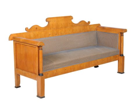  A Biedermeier satin birch and parcel ebonised sofa  , 19th century, the yoke-shaped back above scrolled arms and upholstered